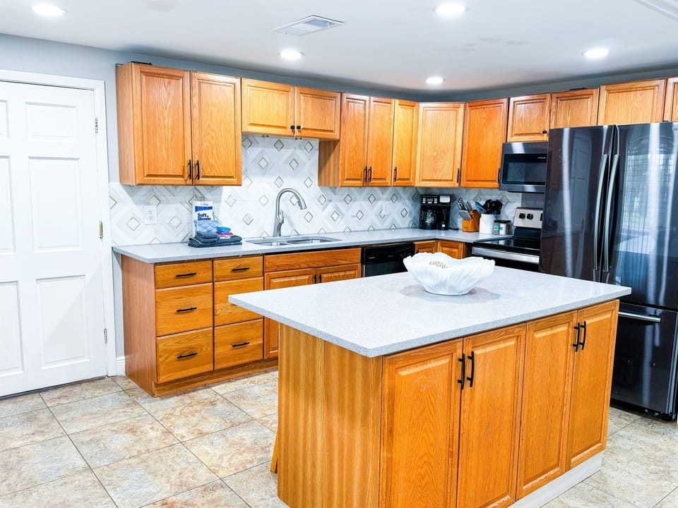 In Unit A, come on in and enter into the open, fully-equipped kitchen where you can cook in.