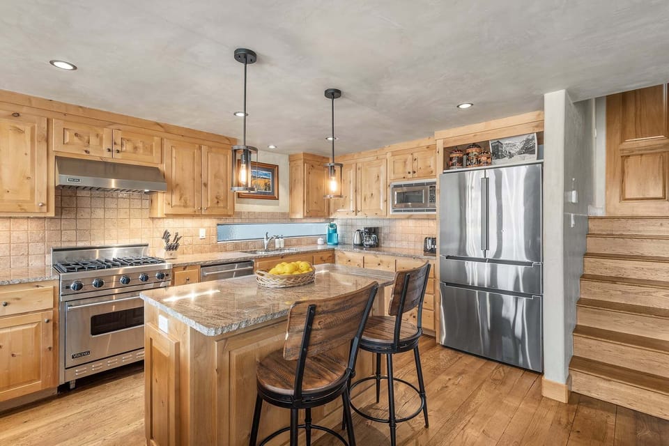Enjoy a spacious kitchen designed for groups, with a central island, bar seating, and everything needed to cook with ease.