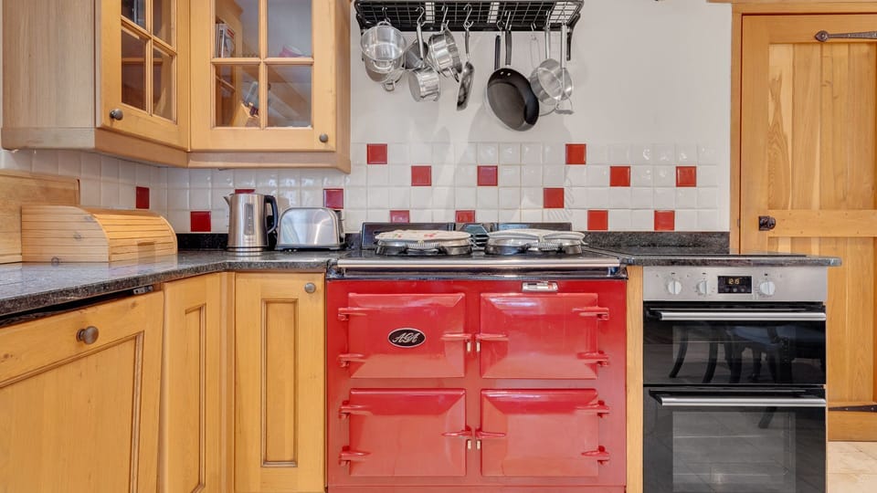 The handsome red AGA is perfect for preparing family dinners.