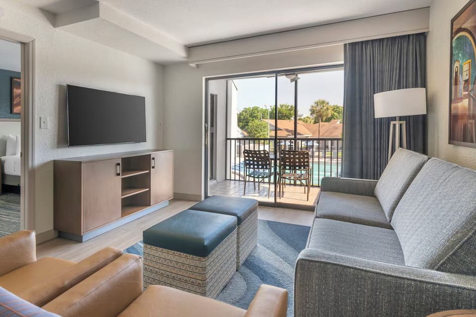 Relax on the roomy sofa beside your bright balcony doors.