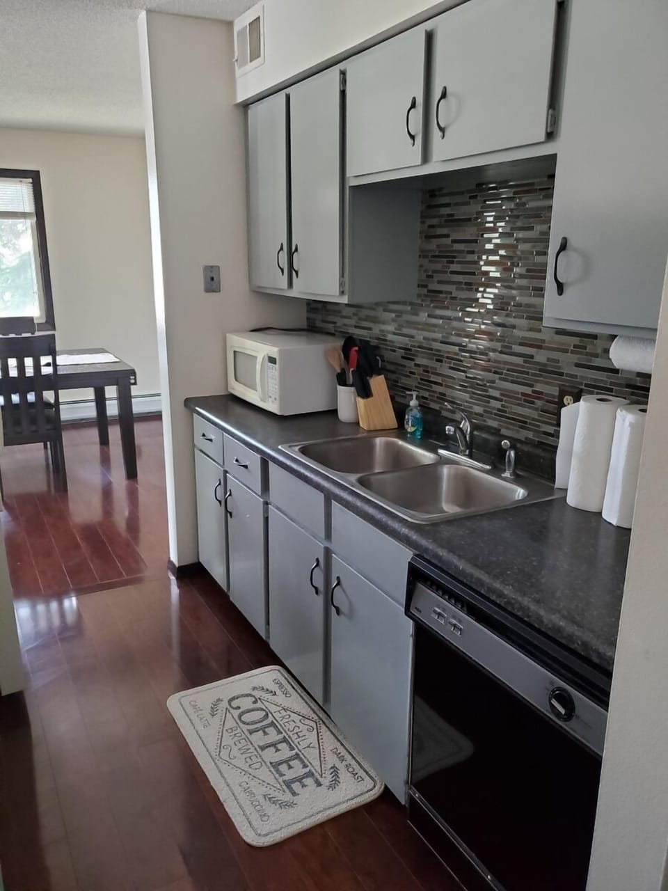 KP101APT1 - Kitchen w/appliances, cook/bake ware, place settings, mircrowave, and coffee machine