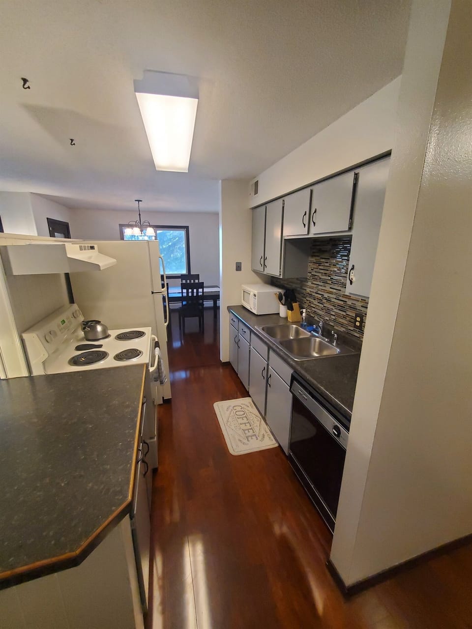 KP101APT1 - Kitchen w/appliances, cook/bake ware, place settings, mircrowave, and coffee machine