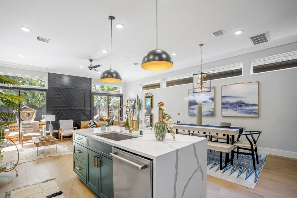 The waterfall quartz island overlooks the dining and living space.