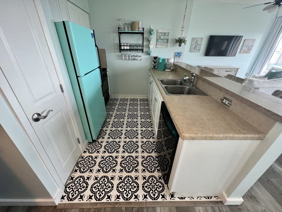 Countertop space with storage cabinets below, crock pot, & Keurig Coffee bar.
