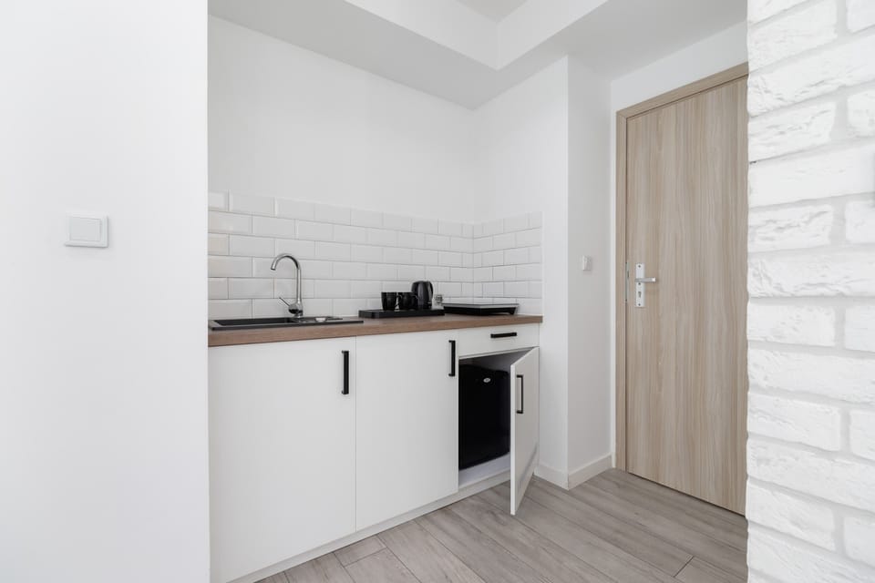 A corner kitchenette with wood accents, providing essential facilities for guests.

