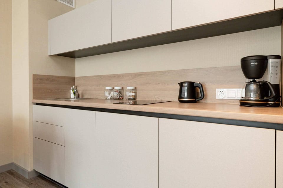 A closer look at the kitchen, showcasing the appliances, utensils, and countertop design.