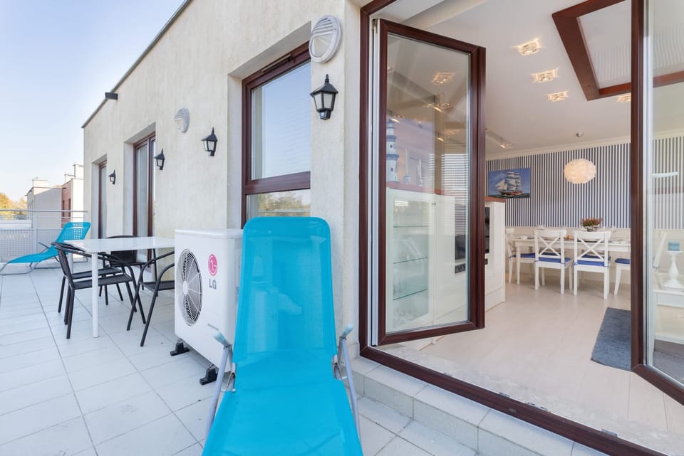 An inviting balcony space with glass doors leading to the interior, perfect for outdoor relaxation.