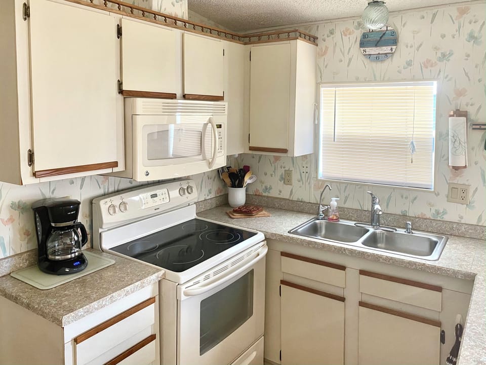 Kitchen includes microwave and full-size refrigerator/freezer