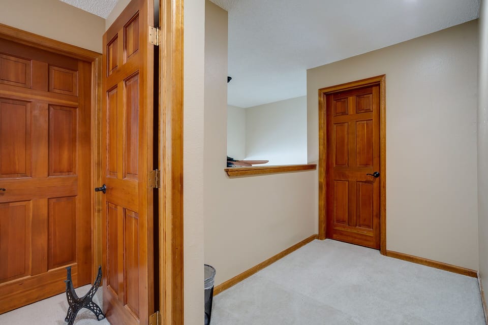 Step into your private hallway featuring beautiful wood doors and trim, creating a warm, homey atmosphere for your stay.