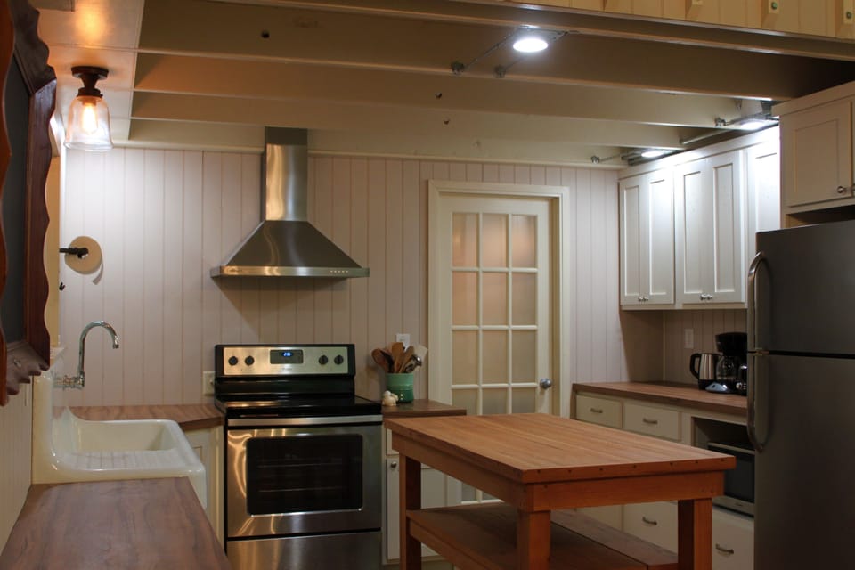 The airy, open kitchen has all the essentials to cook meals during your stay.