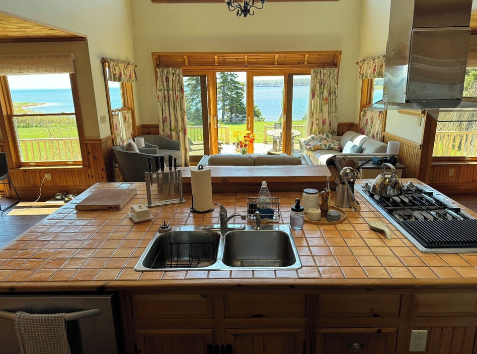 Kitchen with view of sitting area and deck