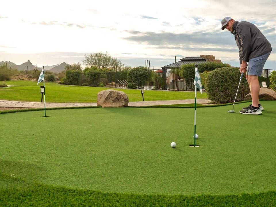 Practice your swing on the private putting green with mountain views