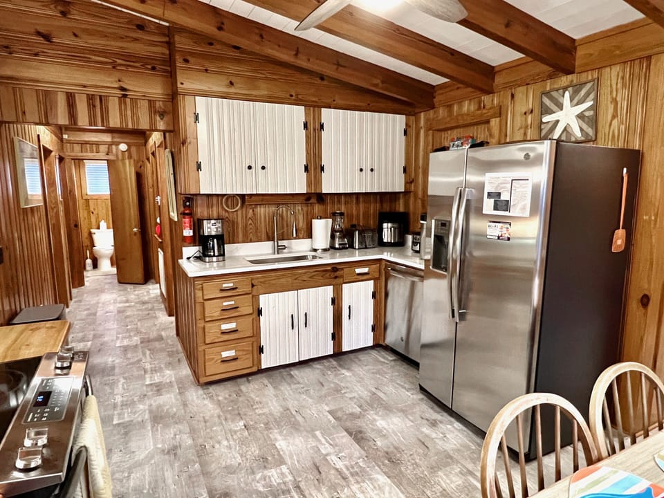 Kitchen - Well-appointed kitchen featuring butcher block countertops, and stainless appliances, and a breakfast bar, ideal for preparing home-cooked meals.