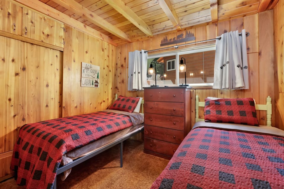 Cozy twin bed with crisp linens and soft lighting, offering guests a restful retreat and inviting atmosphere.
