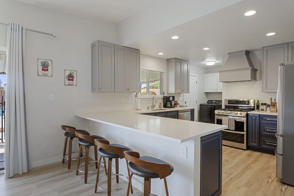 Large breakfast bar with quartz countertop.