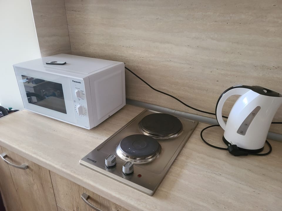  kitchen is equipped with  stove top, microwave, washing machine, tea kattel etc