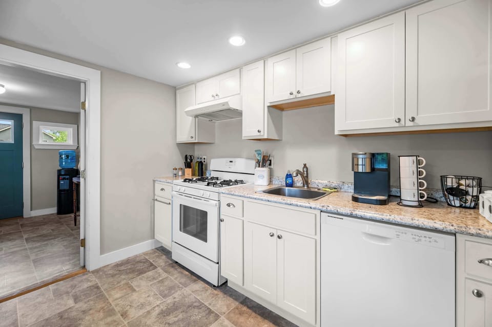 Start your morning with a fresh cup of coffee or gather the family for a home-cooked meal. This bright, fully equipped kitchen includes modern appliances, a Keurig coffee maker, cookware, dishes, utensils,and everything you need to feel right at home