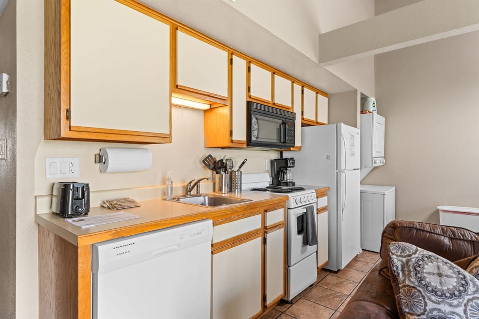 Compact and well-stocked, the kitchen keeps snacks, coffee, and simple meals easy.