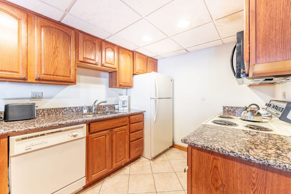 Your fully equipped kitchen features warm wood cabinets, granite countertops, and everything you need to prepare memorable meals during your stay.