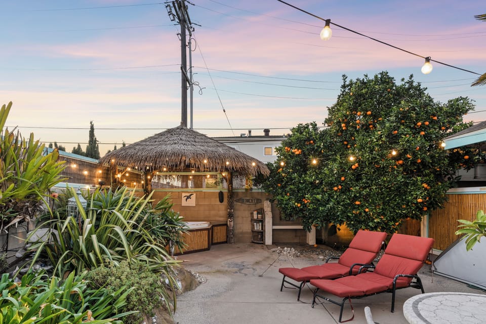Market lights over patio at sunset.