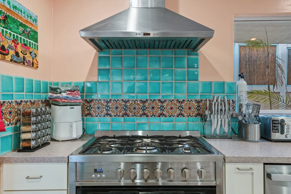 Beautiful tile backdrop to 6 burner custom stove.