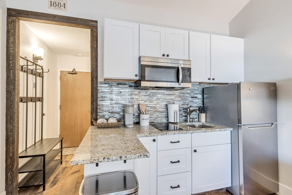 Fully stocked kitchen with 2 burner stove-top and microwave.