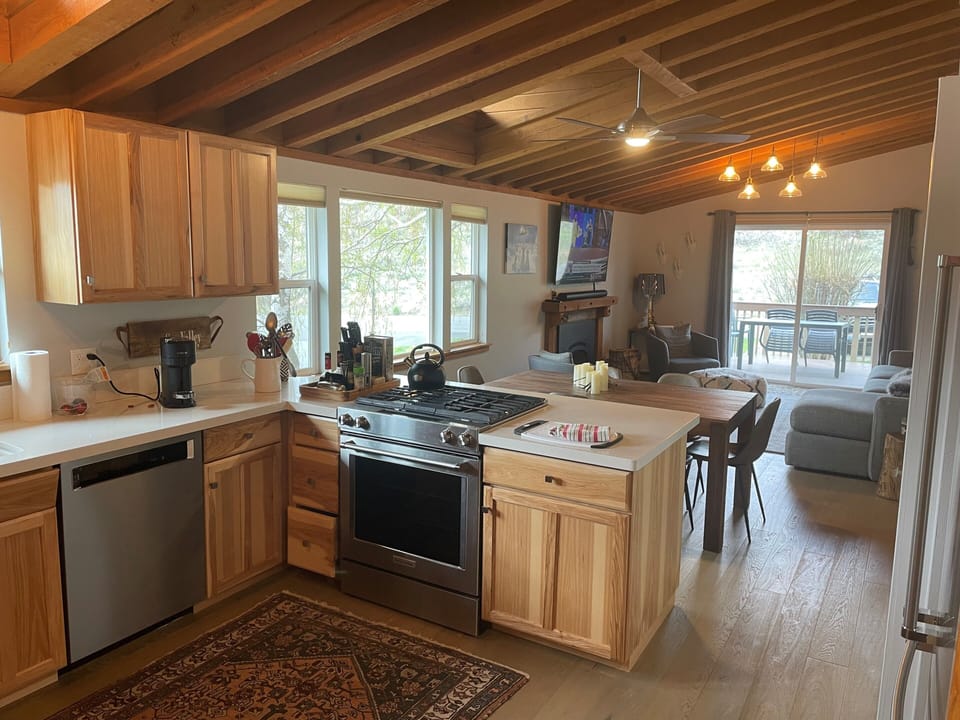 Kitchen facing the dining and living room out to the fenced in patio  