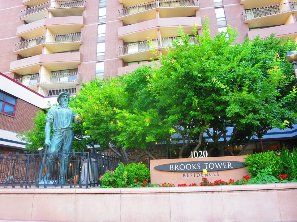 Exterior & facade of the iconic Brooks Tower with a historic Miner's sculpture 