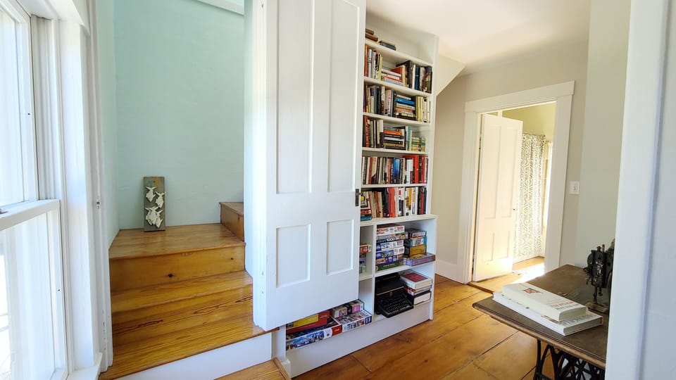 Second floor hall with stairs to third floor