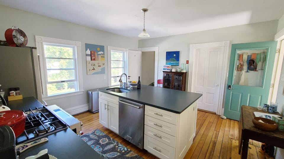 Kitchen has large island and stainless appliances