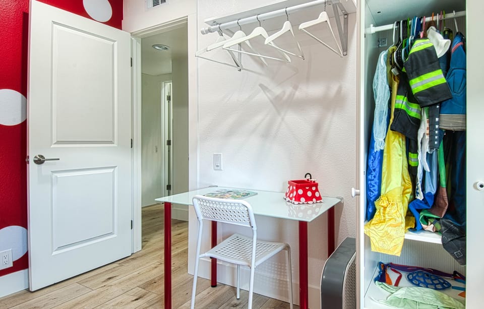 - Small desk setup with chair perfect for kids crafts or homework   - Open closet with hangers keeps clothing organized during stay   - Playful touches create a cheerful and functional bedroom space