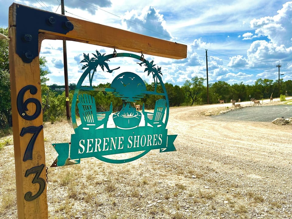 Front sign with deer in background