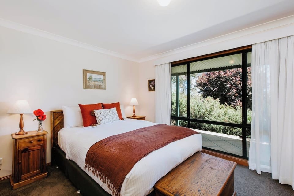 The light and spacious master bedroom comes with a sumptuous queen size bed, TV and floor-to-ceiling windows.