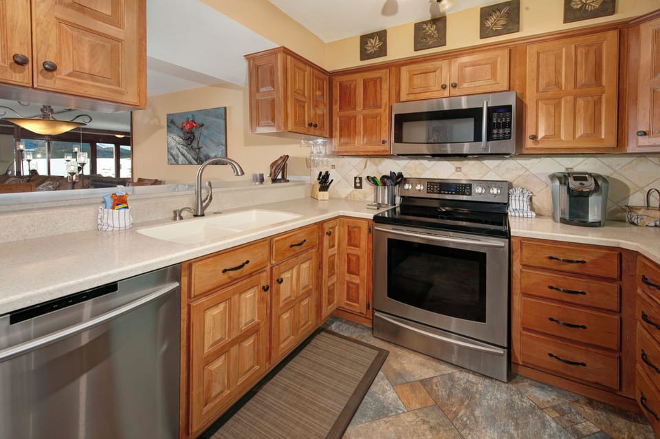 Full size kitchen with stainless steel appliances.
