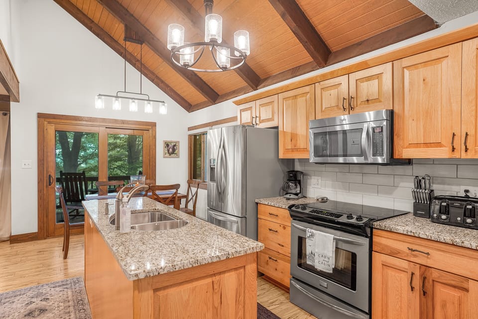 Fully stocked kitchen with granite counters and stainless appliances