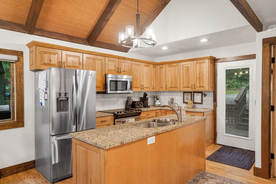 Fully stocked kitchen with granite counters and stainless appliances
