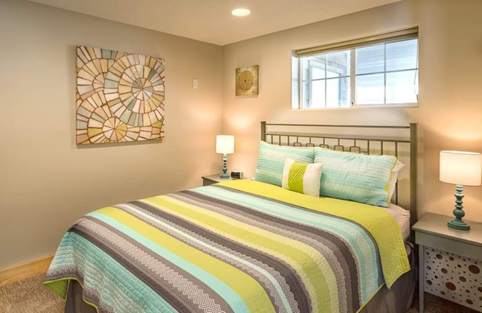 Calm bedroom w/ a cozy bed, soft lighting, and a warm, welcoming feel.