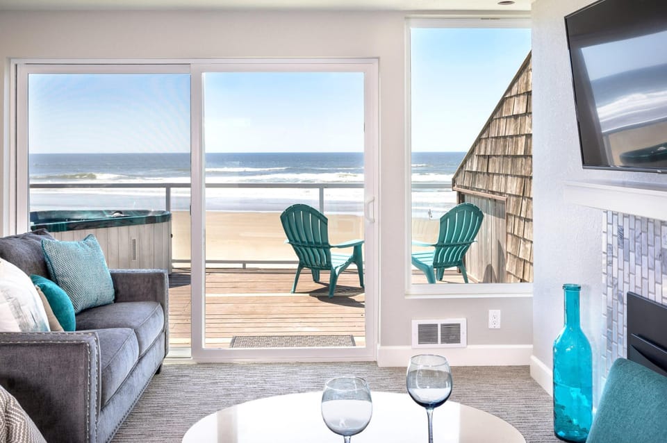 Bright living area opening to the deck w/ sweeping ocean views.