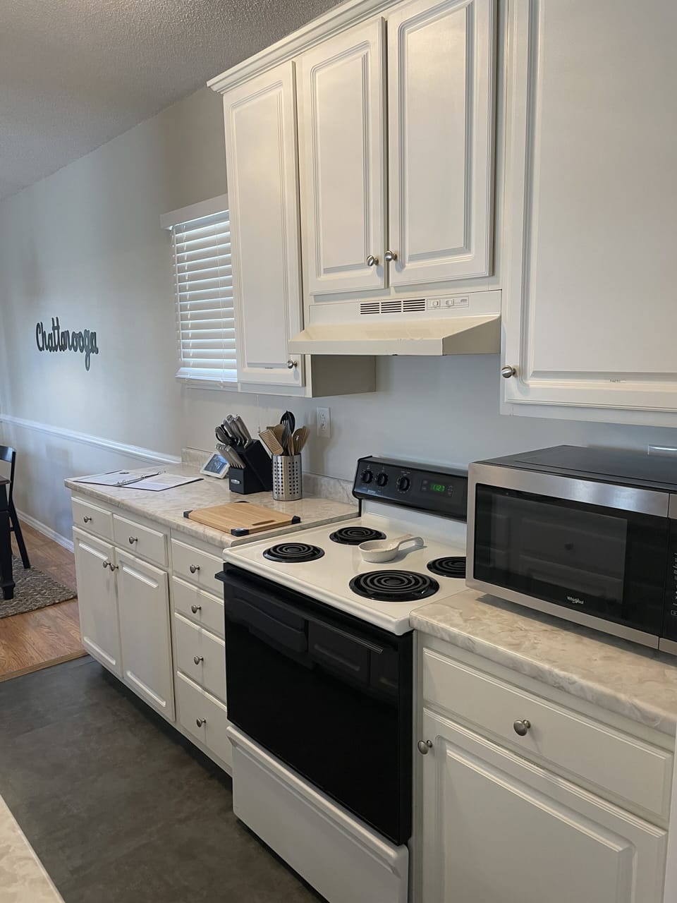 Galley kitchen with microwave and plenty of cabinets!  Labeled to make it easy!