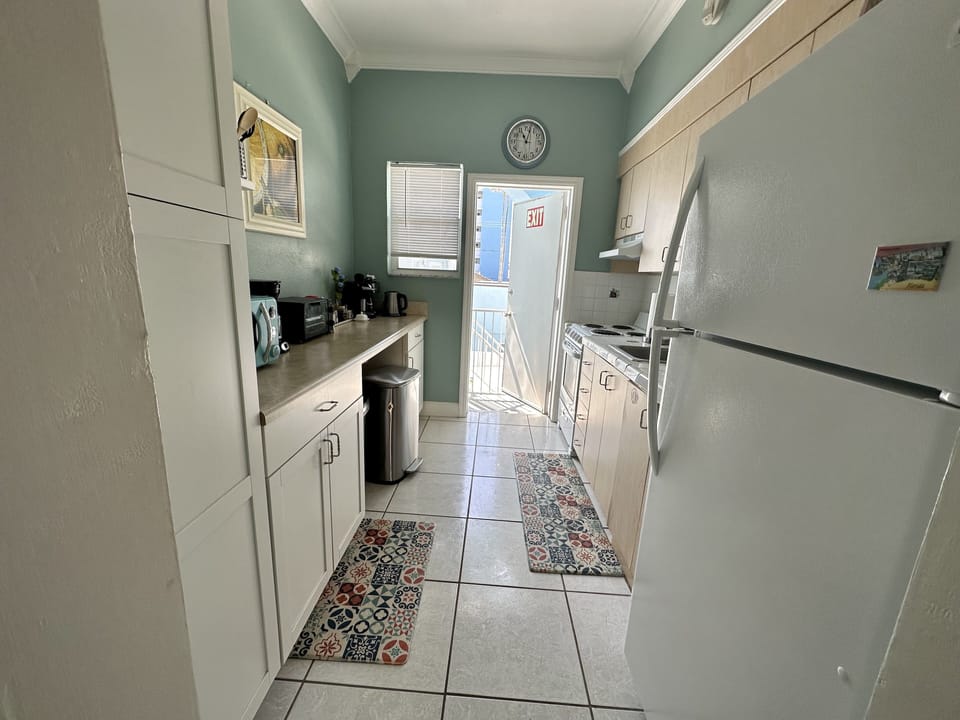Kitchen door. Access to the back of the building, barbecue and pool area.