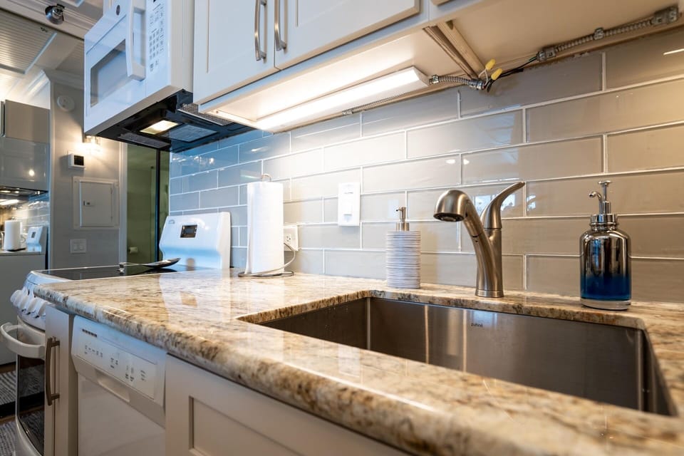 The microwave and white cabinetry add convenience to your stay.