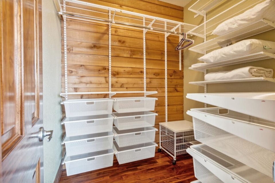 The large, spacious walk in closet in this king bedroom has so much space for those who love packing for everything!