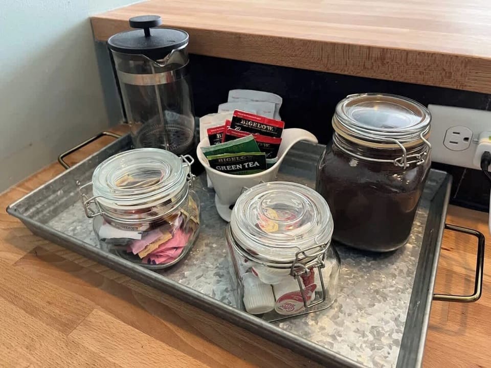 Coffee and tea station with mugs and essentials