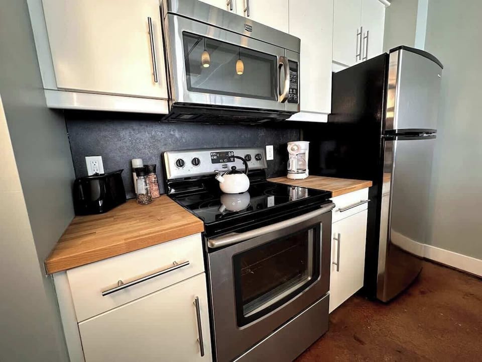 Kitchen with stainless steel appliances and wood counters