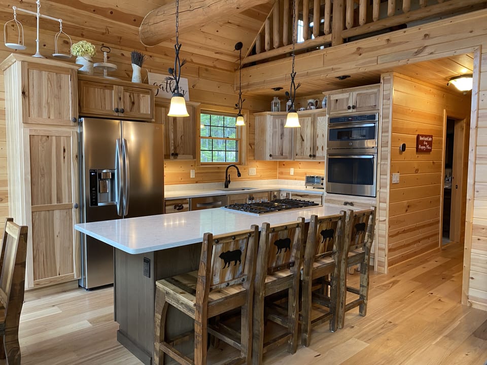 The kitchen with a oversized island. Stocked with everything you need.