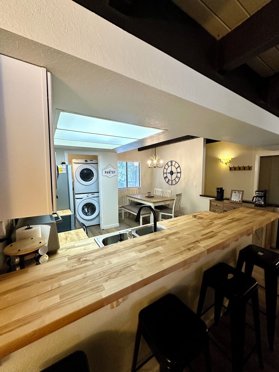 Open floor plan kitchen with bar area and barstools.