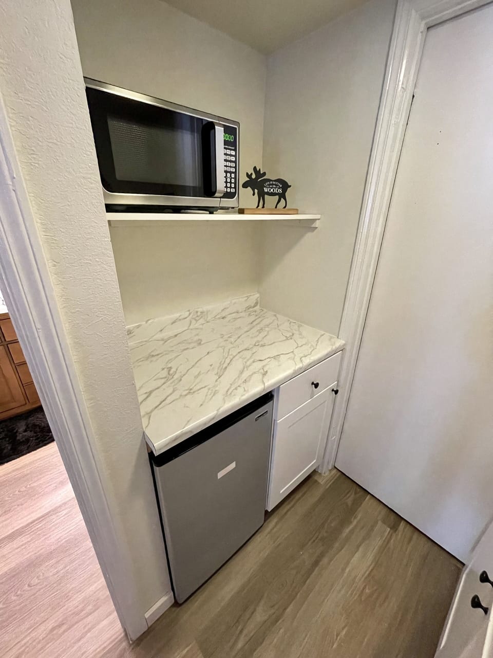 Kitchenette in master suite with sink, mini refrigerator and microwave.