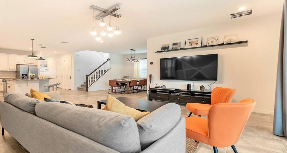 Spacious open-concept living with modern décor, cozy seating, and a big TV! 