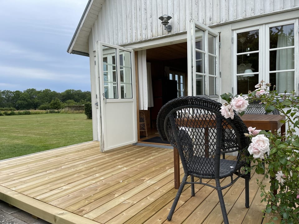 Terrace with front door entrance and view to garden and Reservation