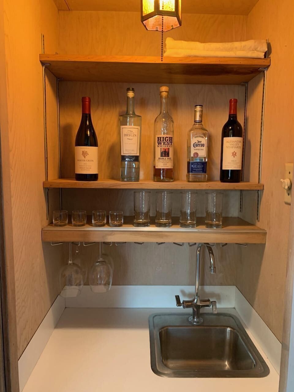 Hidden bar with cocktail fixings and wine. 